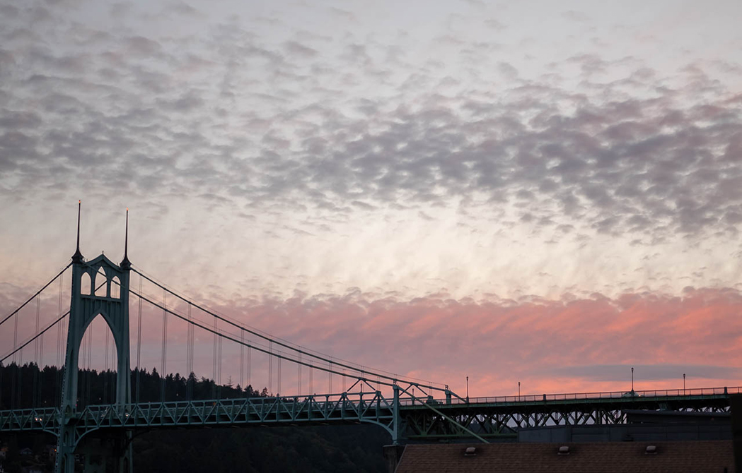 St. Johns bridge at dusk, with pink clouds in the background.