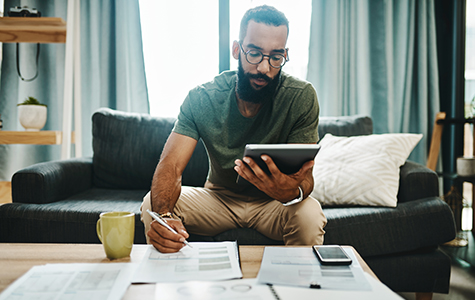 young man reviewing finances at home