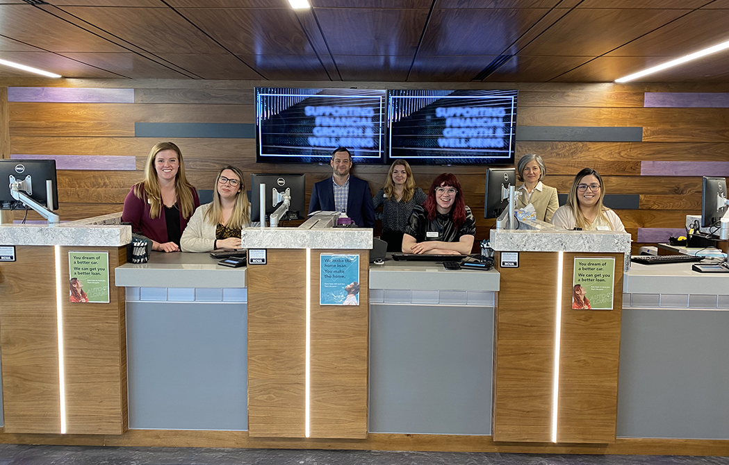 Interior of Lombard branch with employees lined up behind the teller row, celebrating the new North Lombard Branch.