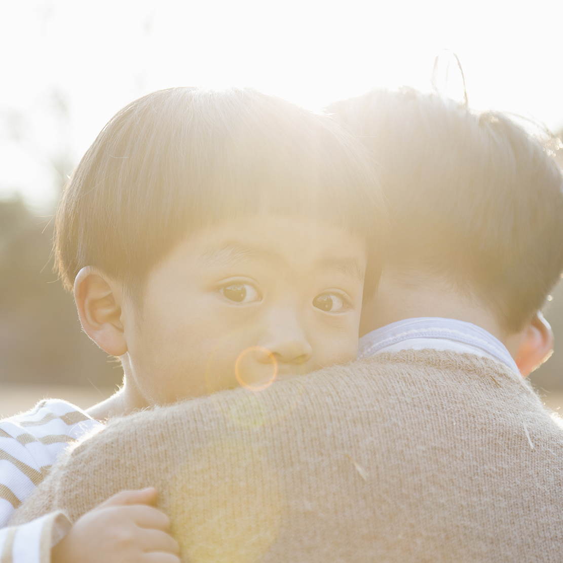 Father embracing crying son
