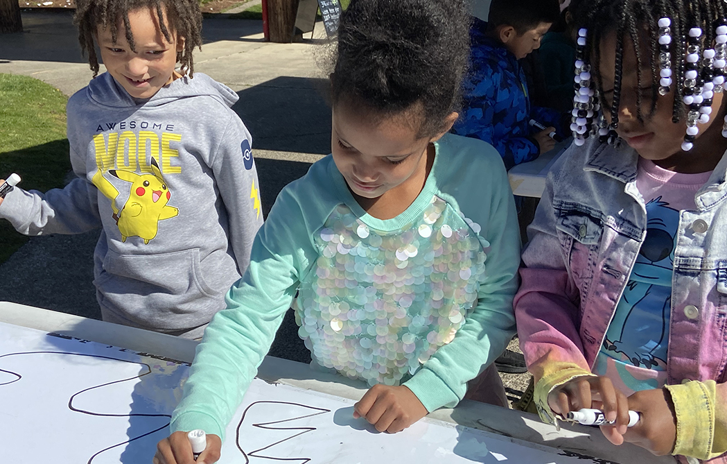 Students from Clear Creek Community work on designing a poster that demonstrates STEAM concepts.