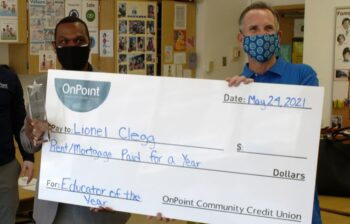 Lionel Clegg presented with check for winning the Educator of the Year Award, K-5 category.