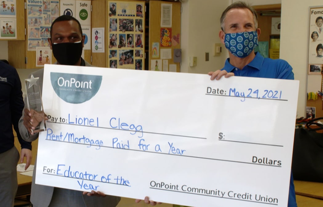 Lionel Clegg presented with check for winning the Educator of the Year Award, K-5 category.