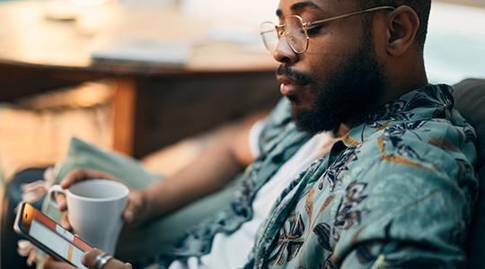 Young millennial using mobile phone to view online banking.