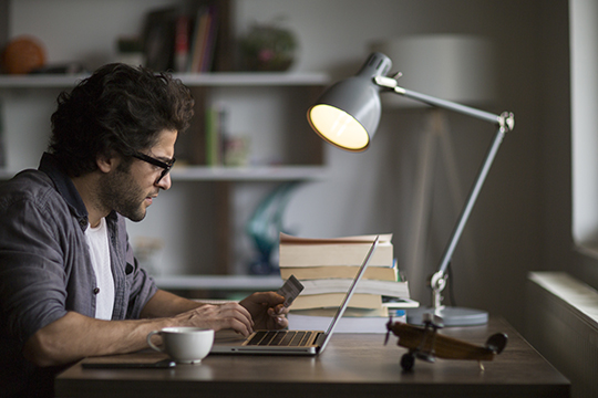 Man is shopping online with laptop