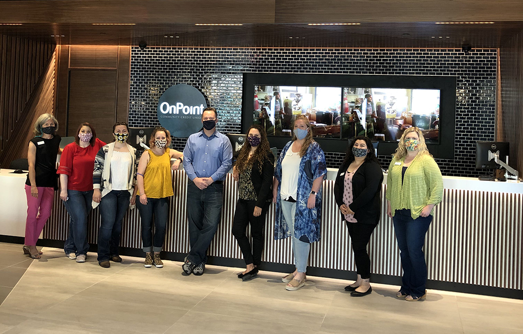 OnPoint employees line up inside the OnPoint's new Sherwood Branch. with masks.