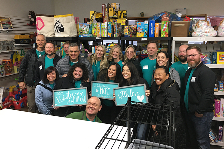 OnPoint employees pose for photo after volunteering with the non-profit organization With Love