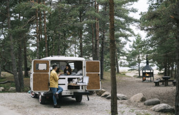 Family enjoying small vacation camping out of their mini van.