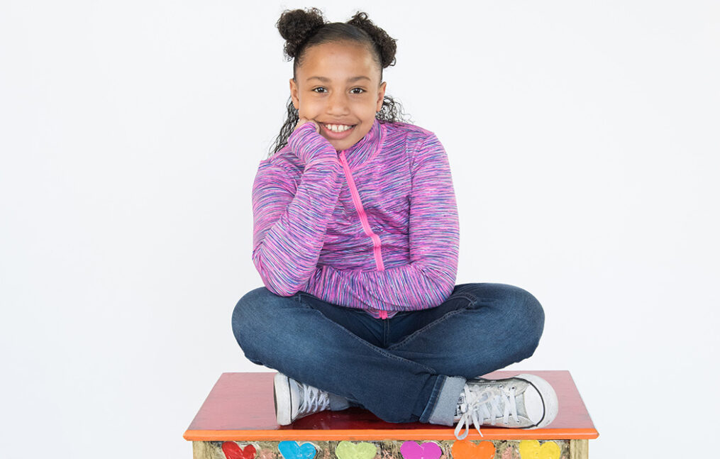 Young girl sitting on table