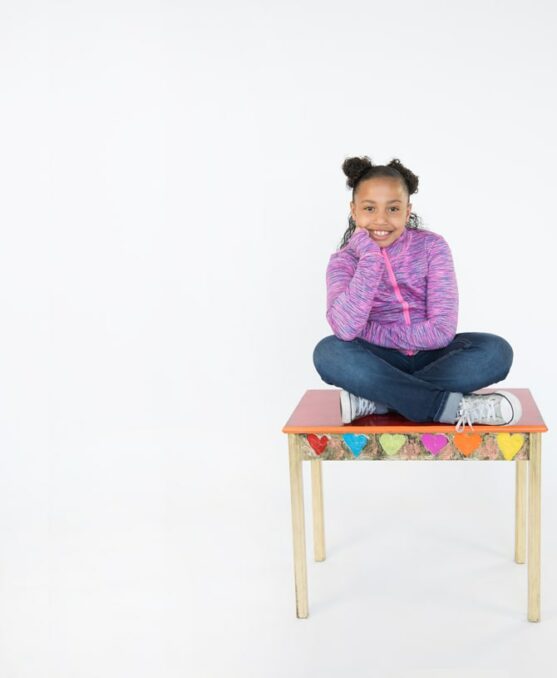 2022-RAF-promo-CCA-hero-young-girl-on-table