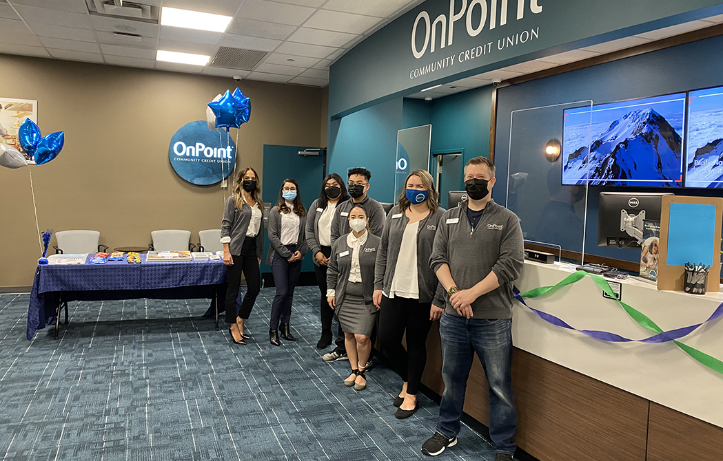 Team members of the OnPoint 67th & Glisan branch line up to celebrate the opening of their new branch.