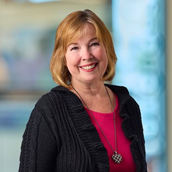 Kim Blanquie OnPoint Mortgage Professional Headshot Bank Back drop