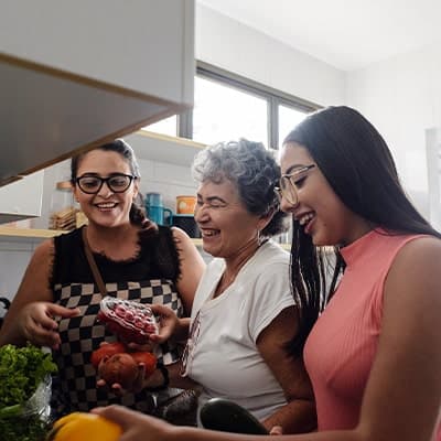 two granddaughters cooking with grandma 