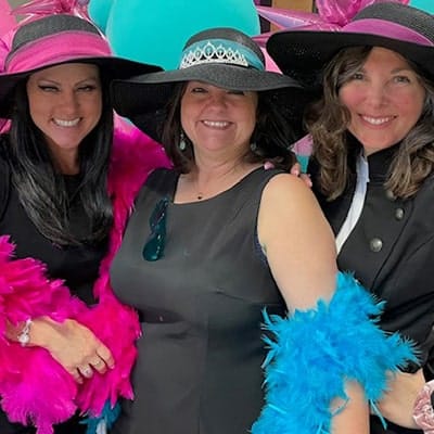 three woman wearing hats