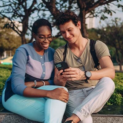 couple-looking-at-phone-outside