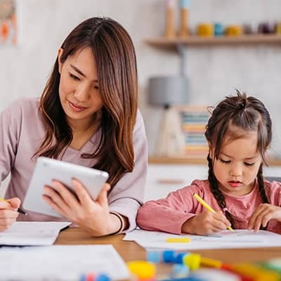 mom-and-daughter-working-on-homework-and-work-together