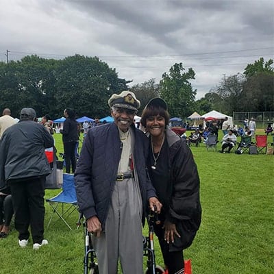 Two older black folks smiling 