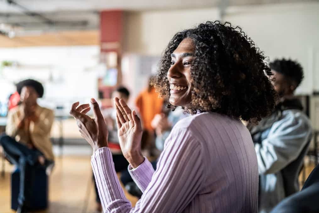 woman-smiling-and-clapping-her-hands