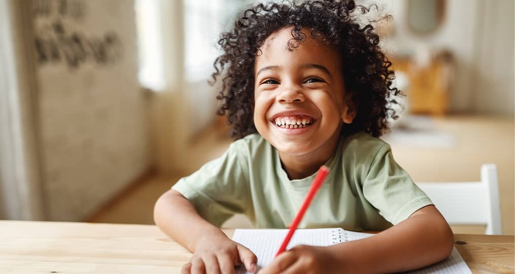 boy-smiling-sitting-in-desk