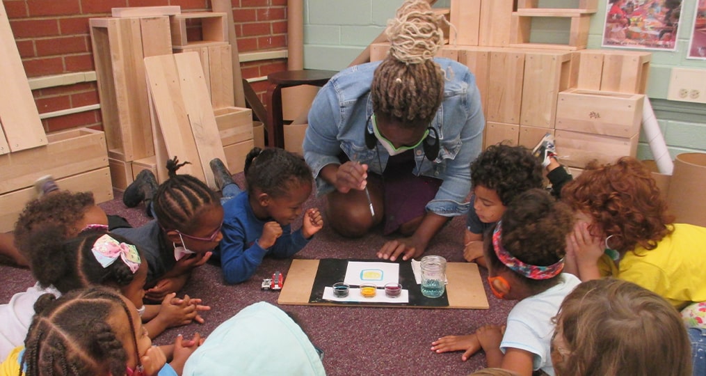 Teacher helping kids with a science project