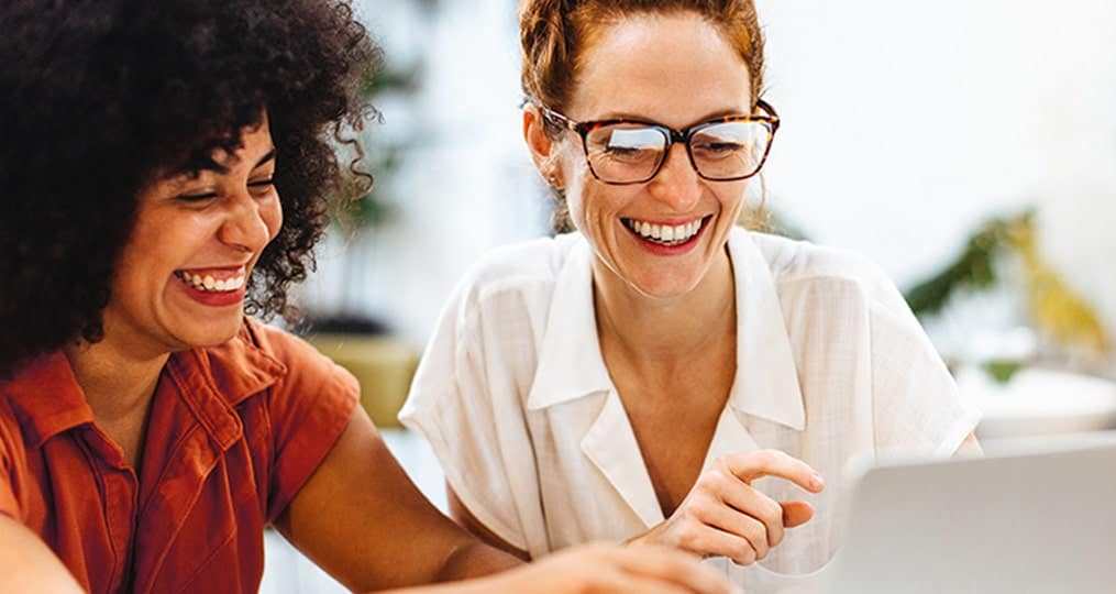 two-happy-women-using-a-laptop