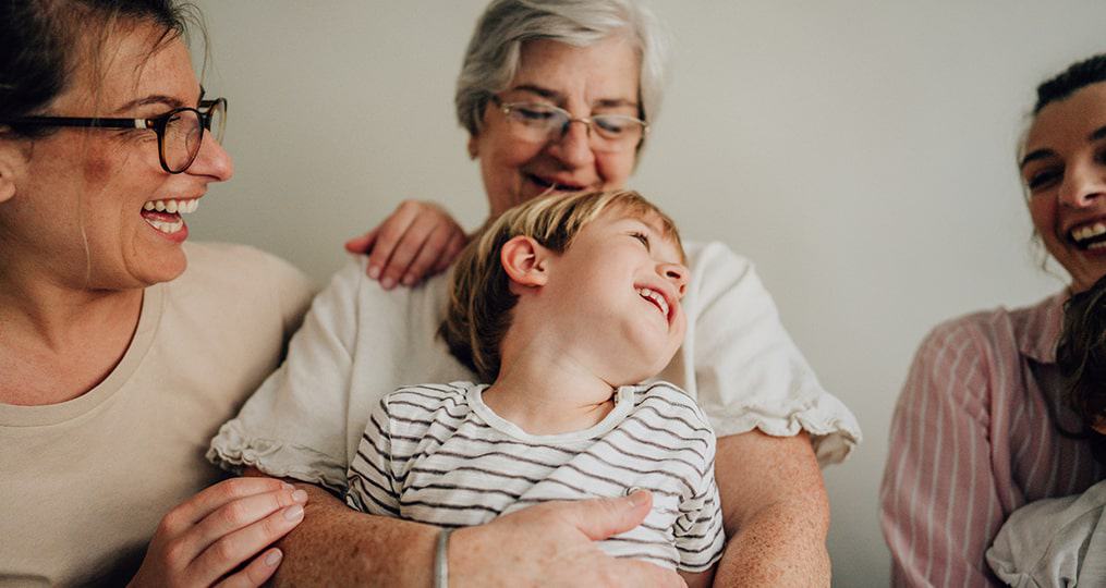 child-held-by-grandma-and-mom