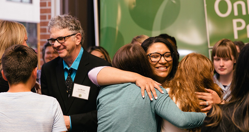 Francesca Aultman OnPoint Prize Award Announcement hugging students