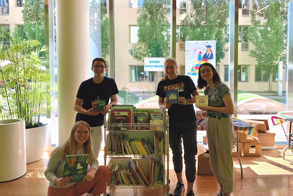 Community Impact Story - Babies With Books_Benjamin and other students holding books at the hospital