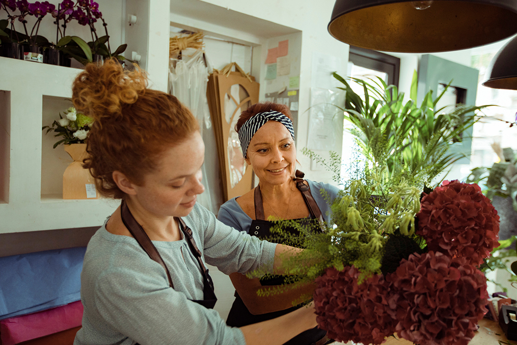 Flower Shop Owner working with her employee on a customer order