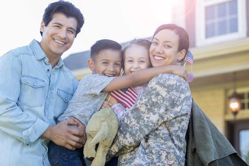 Servicemembers Are You Using All of Your Military Benefits_Military Member with family outside her house