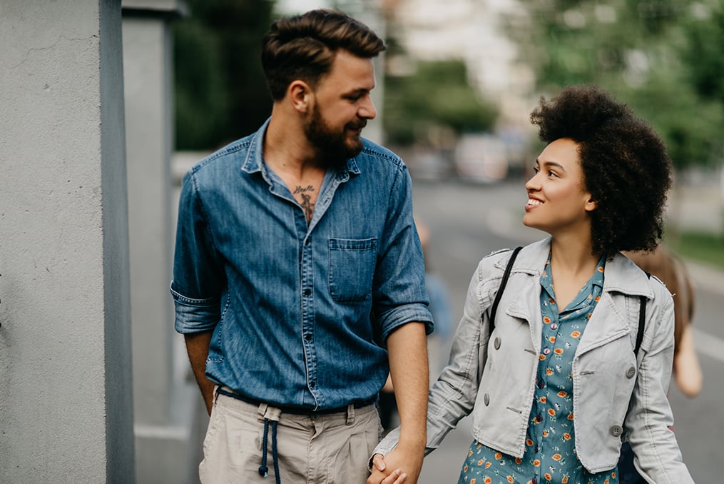 couple walking down the street holding hands