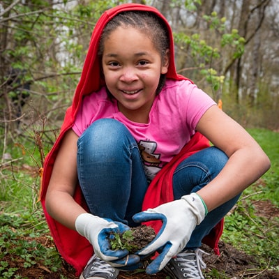 girl-holding-a-plant-outside