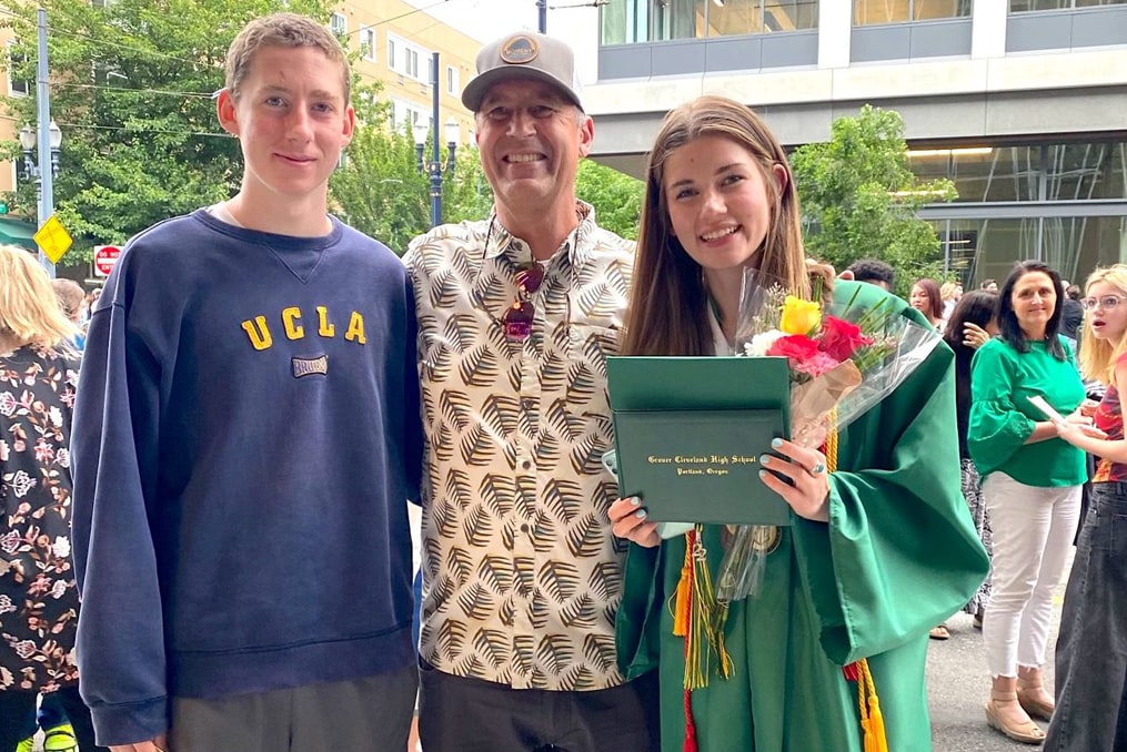 Stella Blaha at graduation with brother and father