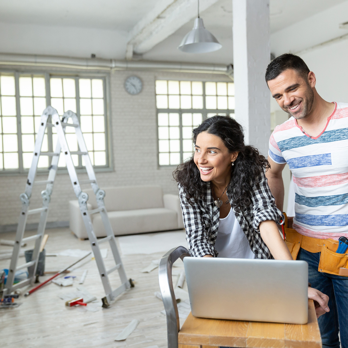 7 Home Improvements That Can Increase the Value of Your House in Oregon_woman and man looking at laptop while remodeling home