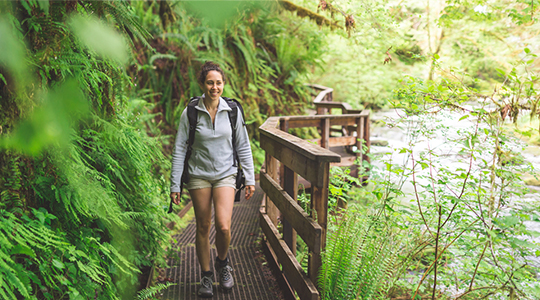 Credit eBook_Young woman hiking through the woods contemplating her finances