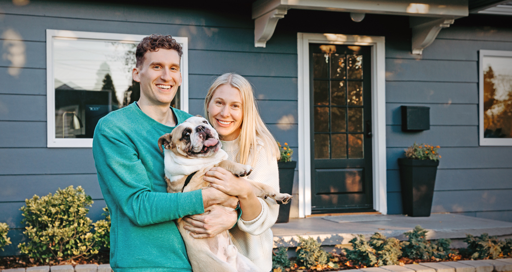 Employee Spotlight with Dannielle Stuart_Dannielle and Eric in front of their house