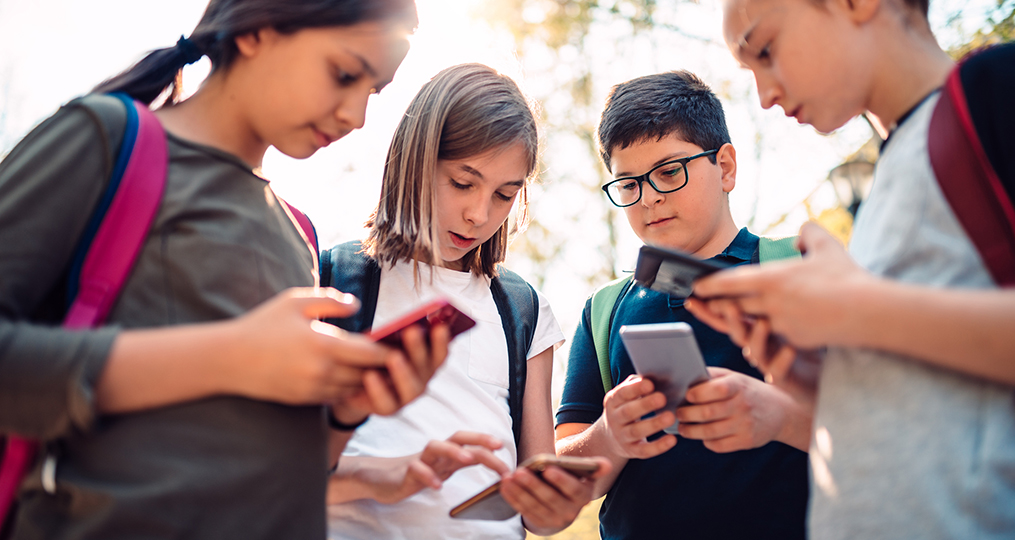 Essential Tips for Securing Your Family's Mobile Devices_Kids using smartphones after school