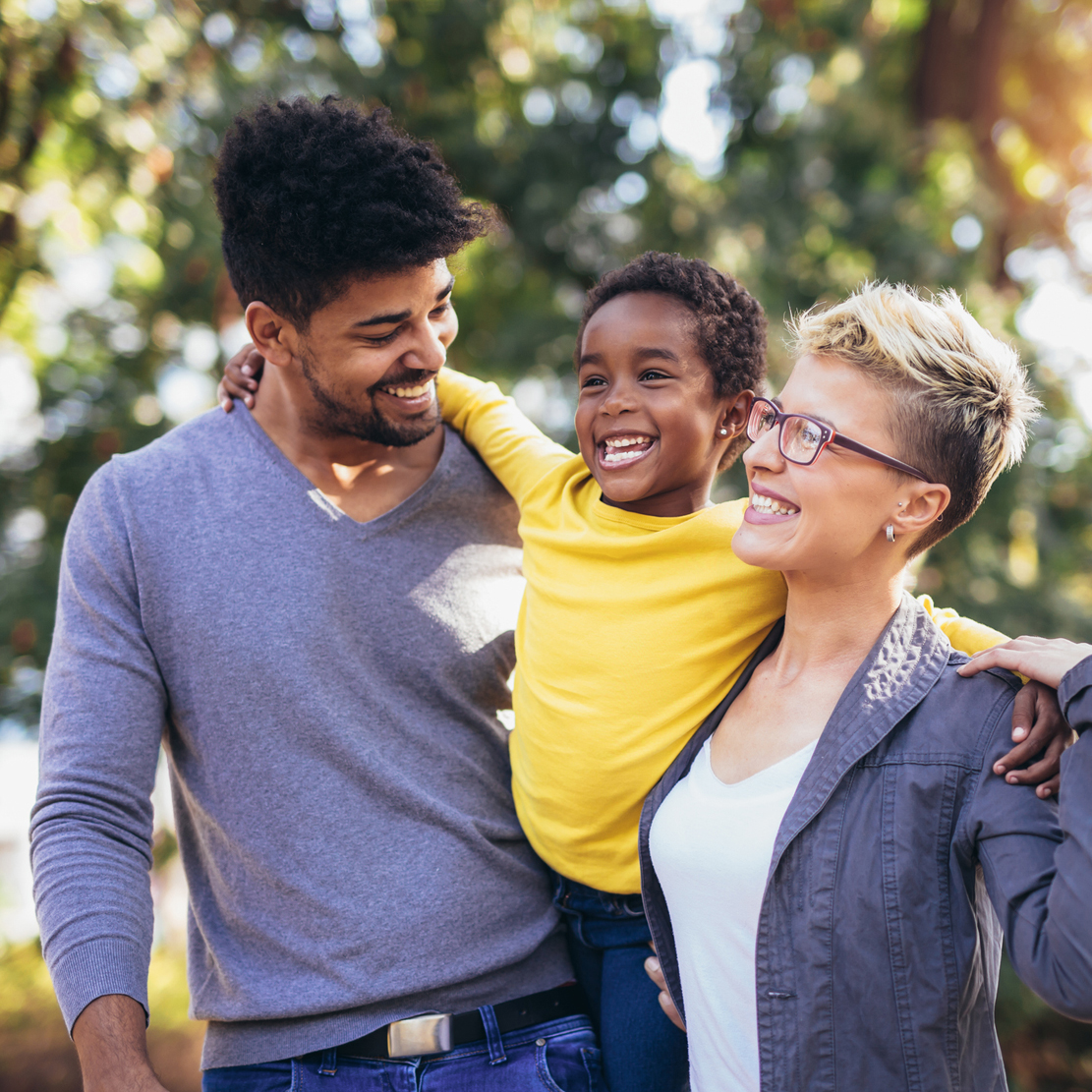 How much will a college education cost in 2030_two parents carrying their young child
