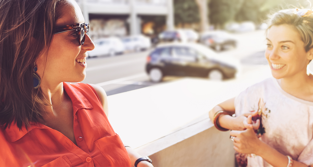 How to Buy Your Next Car with Confidence_Two women talking with car in the background