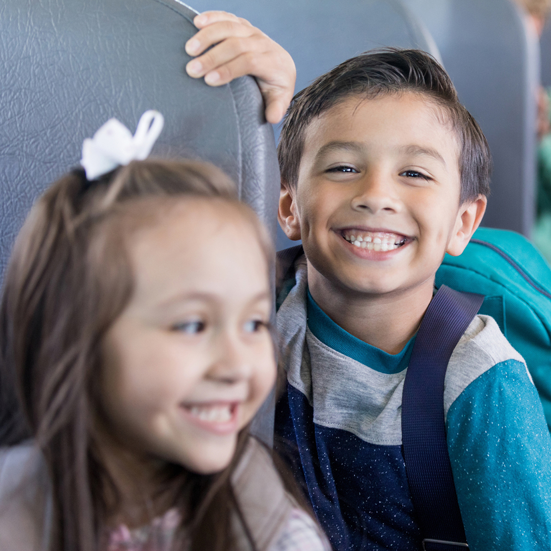 How to Get the Most From Your 529 Plan_young boy smiling on the school bus