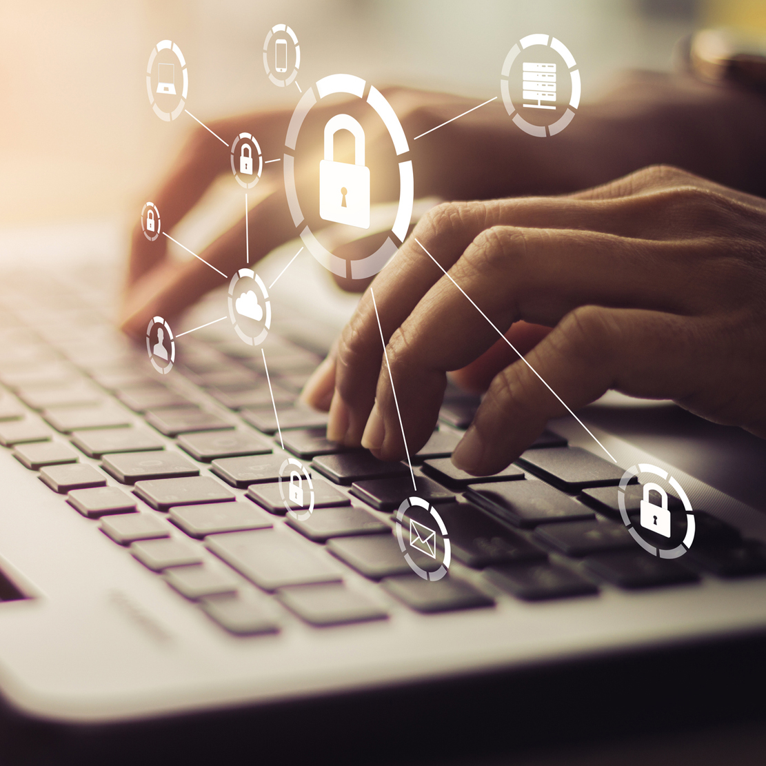 hands typing on a computer with icons related to cyber security