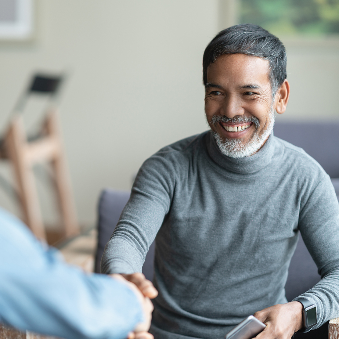 Mature asian man making an agreement through a handshake