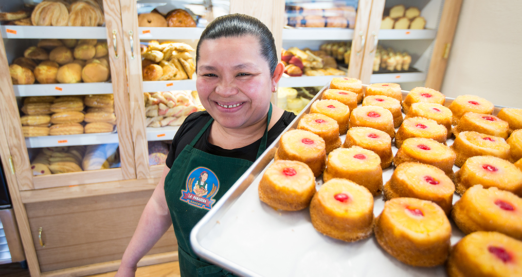 OnPoint Employees Direct $91,000 to Local Non-profits_woman holding a pan of pastries