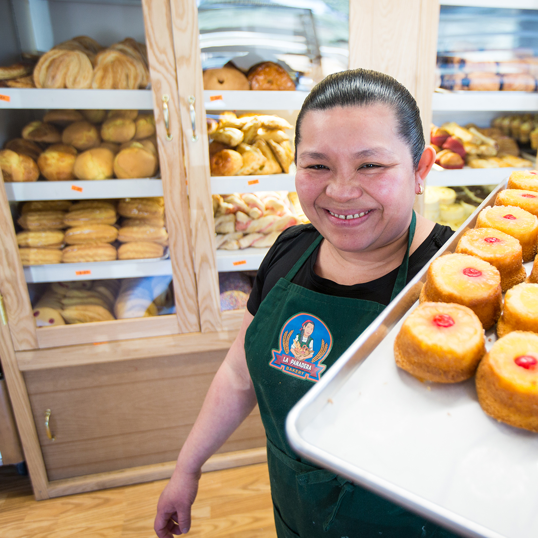 OnPoint Employees Direct $91,000 to Local Non-profits_woman holding a pan of pastries