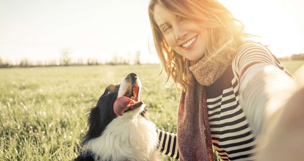 Personal Loans-What Your Options Are and When Should You Get One_Smiling lady taking selfie with her dog