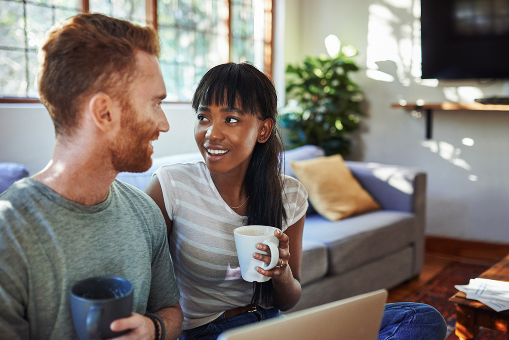 The difference between good and bad debt_Man and woman discussing finances and drinking coffee