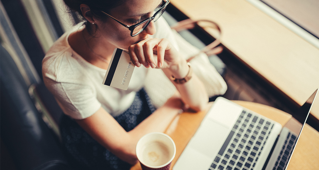 When does a balance transfer credit card make sense_contemplating a new credit card while enjoying a cup of coffee