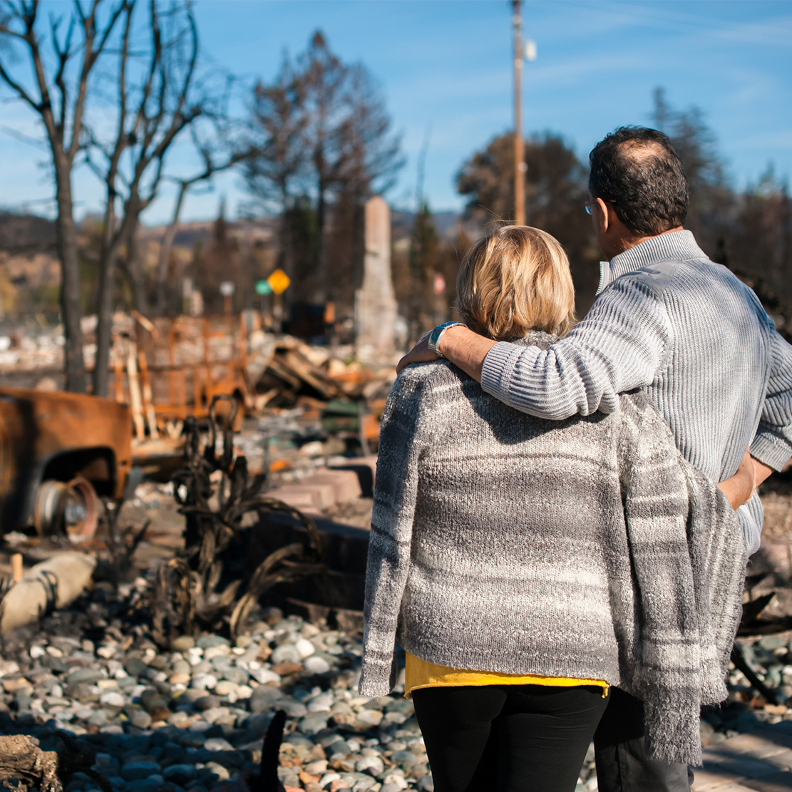emergency preparedness and disaster planning in the pacific northwest_couple looking over aftermath of a fire