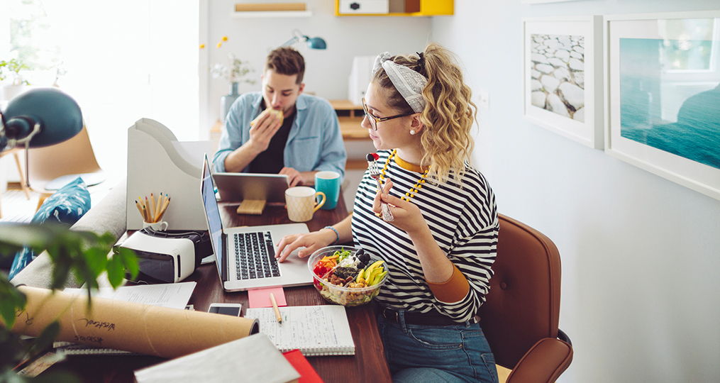 the state of personal financial education_young woman sitting at a table reviewing financial education resources