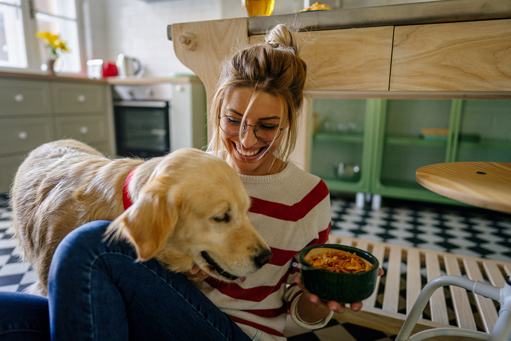 what young adults need to know about generational changes in spending habits_young woman laughing while holding a bowl of food